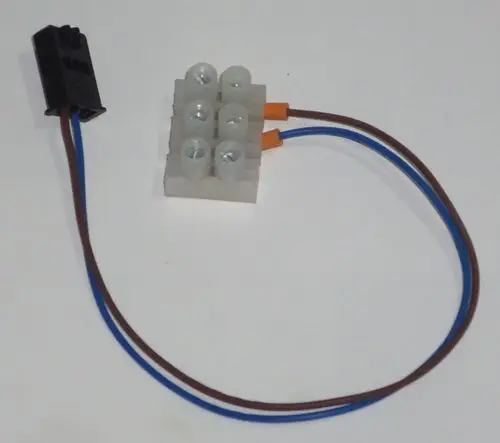 PWM-Pumpenverbindung von Daikin mit einem schwarzen Steckverbinder und drei farbigen Kabeln, die an eine Verbindungseinheit mit Schraubklemmen angeschlossen sind.
